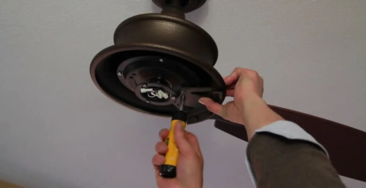 Electrician installing ceiling fan mounting bracket and fixture in Palm Springs, CA