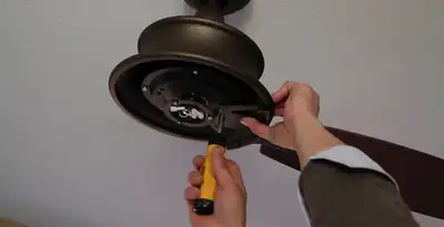 Electrician installing ceiling fan mounting bracket and fixture in Palm Springs, CA