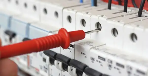 Electrical contractor testing circuit breakers during electrical repair in Palm Desert, CA