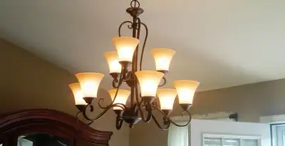 Classic ceiling chandelier installation with warm lighting in Palm Springs, CA