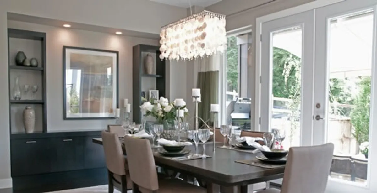 Elegant dining room chandelier installation above table in Palm Springs, CA