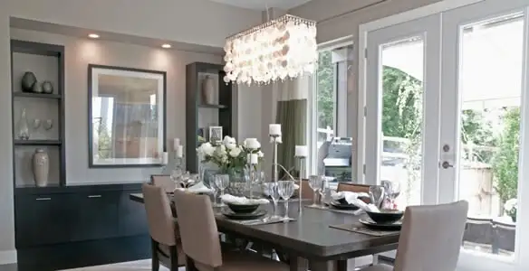 Elegant dining room chandelier installation above table in Palm Springs, CA