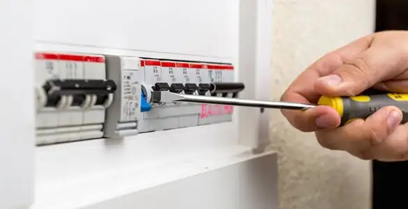 electrical panel upgrade service showing technician adjusting circuit breakers during system upgrade in Palm Springs, CA
