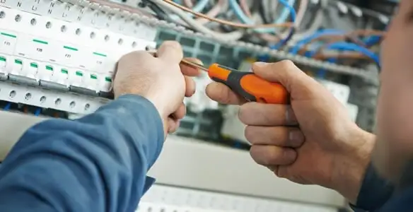 electrical service showing licensed electrician performing electrical panel maintenance and adjustments in Palm Springs, CA