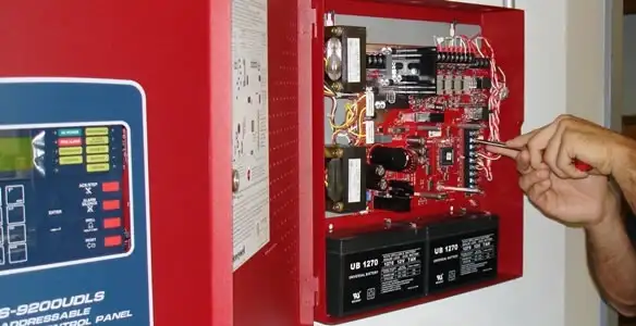 fire alarm installation service showing technician configuring fire alarm control panel in Palm Springs, CA