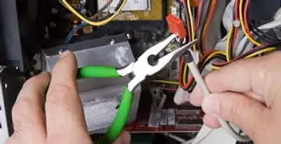 Licensed electrical contractor performing electrical repair with tools in Desert Hot Springs, CA