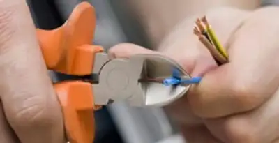 professional electrical services showing precise wire cutting by licensed electricians in Palm Springs, CA