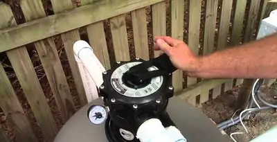 pool pumps service showing professional adjustment of pool pump control system in Palm Springs, CA