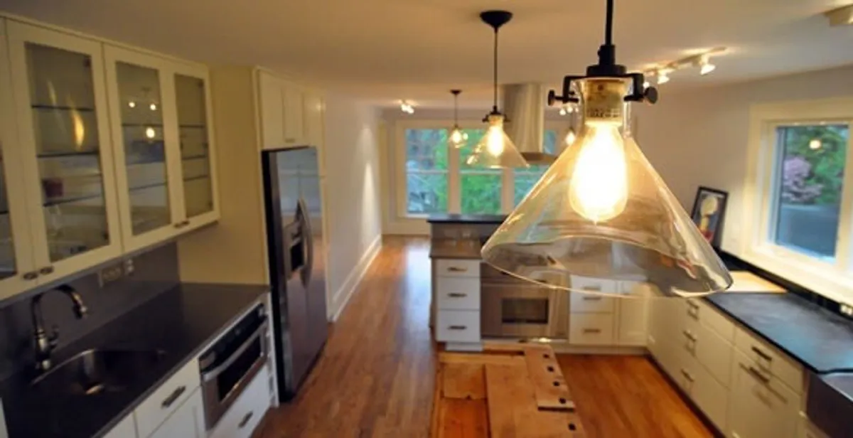 Residential electrician installing modern indoor light fixture in a home in Palm Springs, CA
