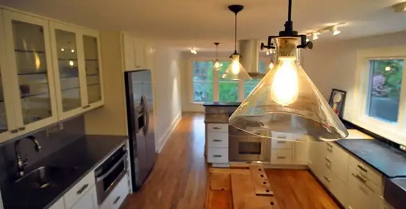 Residential electrician installing modern indoor light fixture in a home in Palm Springs, CA